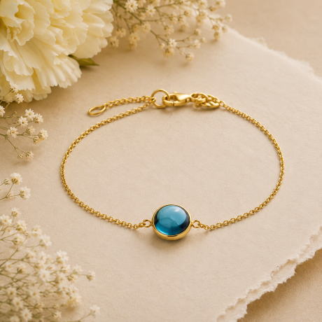 Geelgouden schakelarmband met london blue topaas
