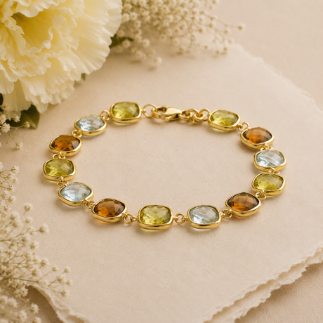 Geelgouden schakelarmband met edelstenen mix